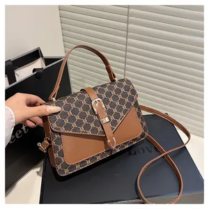 Detail of the vintage canvas and brown leather patchwork texture and metal buckle clasp