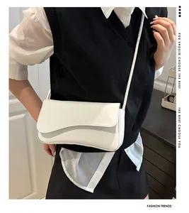 Detailed view of stitching and texture on a minimalist cream leather underarm bag
