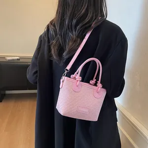 Pink woven bucket bag with top handle and fashion logo for summer women's style