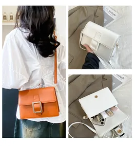 Internal capacity detail of minimalist square crossbody bag with orange and white options