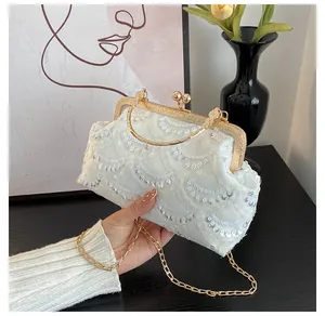White lace evening clutch bag with silver sequins, gold metal handle and chain strap