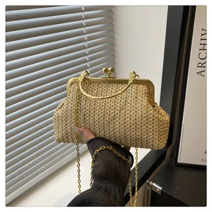 Detail of vintage straw shell bag with gold kiss-lock closure and metal handle