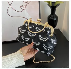 Elegant black lace evening bag with silver sequins, gold metal handle and chain strap