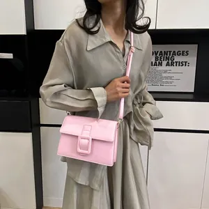 Pink rectangular crossbody bag with square buckle and adjustable strap for women