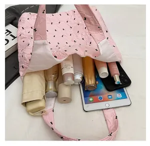 Interior detail of pink quilted tote bag showing spacious capacity for daily items