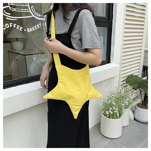 Close-up of vibrant yellow star-shaped crossbody bag with detailed stitching