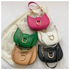 Detailed flat lay of five colorful crescent shoulder bags with gold D-ring buckles