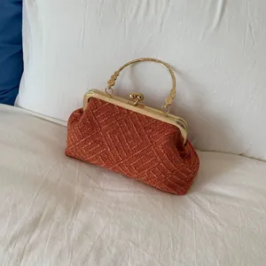 Vintage brick red beaded evening bag with golden metal frame clasp and intricate woven texture