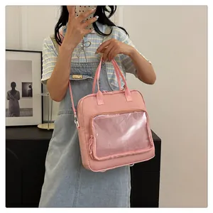 Detailed view of pink multi-functional transparent bag worn by a model in a casual setting