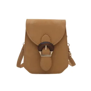 Minimalist camel crossbody square bag with vintage buckle on a clean white background