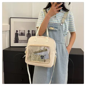 Detail of off-white multi-use bag with large transparent PVC pocket for displaying items