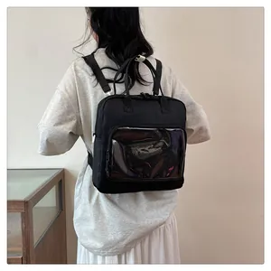 Detailed view of black multi-use backpack featuring a large transparent pocket for display
