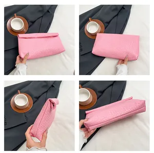Detailed views of pink woven envelope clutch showing four-way texture and folding structure