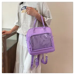 Detail of purple ita-bag showing transparent PVC window and adjustable shoulder straps