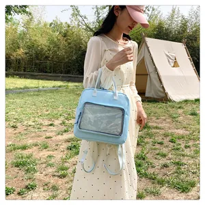 Outdoor view of light blue multi-use ita bag with large transparent display window