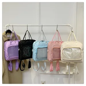 Detailed view of large clear Itabags in five colors hanging on a studio display rack