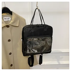 Detail of black nylon tote bag with transparent PVC window for doll display