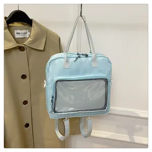Close-up of the light blue backpack with a transparent mesh front pocket and straps