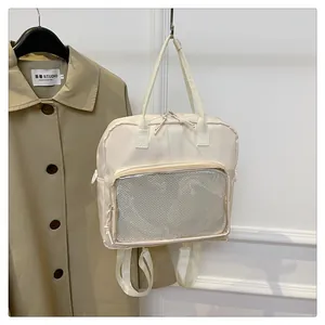 Detail of cream-white transparent mesh compartment on large capacity multi-use backpack
