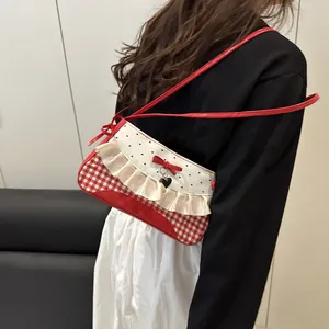 Sweet red checkered underarm bag with ruffled trim and heart pendant detail