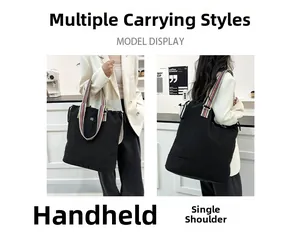 Detail of black canvas tote bag with colorful striped handles for shoulder or hand carry