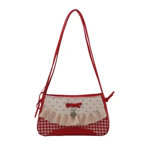 Y2K style red plaid baguette bag with lace trim, heart print and bow detail