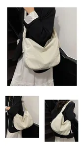 Close-up of large canvas crossbody bag showing textured fabric and slouchy style