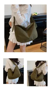 Detail of adjustable wide shoulder strap on olive green canvas large messenger bag