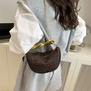 Brown woven crescent bag with golden metal handle and chain strap for women