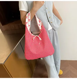 Detail of red gingham pattern with side bow tie and soft inner lining on tote bag