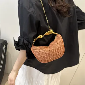 Chic woven handbag with twisted gold metal handle and chain strap for women
