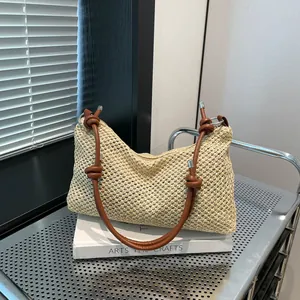 Sac cabas en paille tissé à la main avec anses en cuir nouées sur chariot en métal
