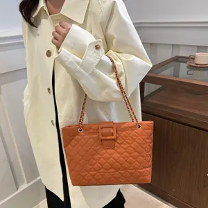 Orange quilted leather tote bag with gold chain strap and square buckle detail