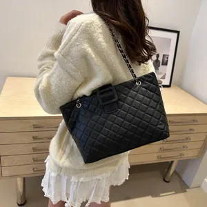 Fashionable black quilted tote bag with chain strap and large buckle for elegant women