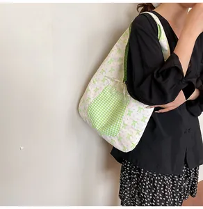 Detail of floral tote bag showing green gingham pocket and bow tie strap details