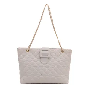 Elegant grey quilted tote bag with chain strap and square buckle on white background