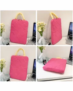 Detailed views of a pink quilted laptop sleeve with yellow handles and floral stitching