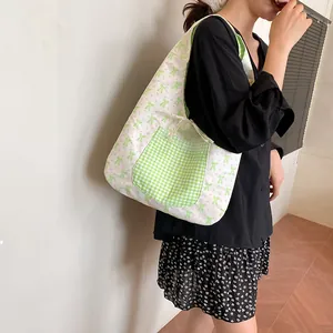 Women's floral canvas tote bag with green bow print and plaid pocket for summer travel