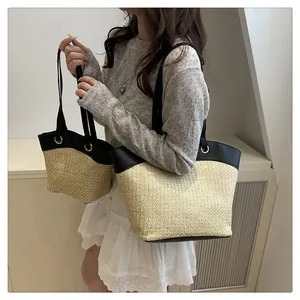 Détails du sac en paille tressée avec bordure en cuir noir et œillets sur la bandoulière