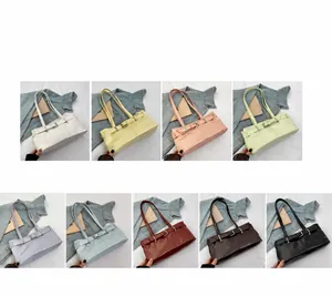 Detail view of baguette underarm bags in nine vibrant colors with metal buckle accents