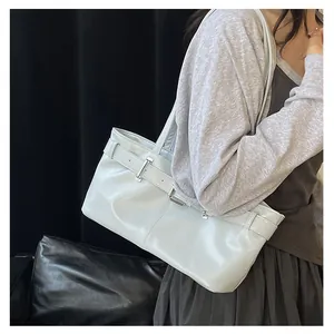 Detail of light blue baguette bag featuring strap buckle and silver metal hardware