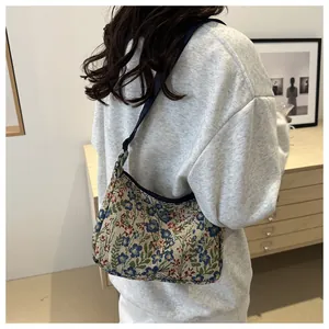 Detailed view of vintage floral tapestry fabric on a large hobo shoulder bag
