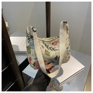 Close-up of floral jacquard fabric and adjustable strap on a hobo shoulder bag