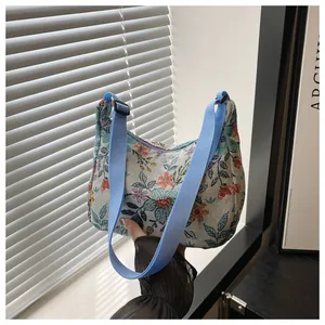 Floral print fabric shoulder bag with blue nylon strap and retro jacquard patterns