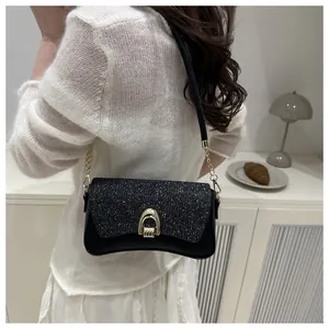 Détail du sac à bandoulière noir pailleté avec boucle fer à cheval dorée et chaîne