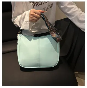 Detail of mint green tote bag featuring a wide vintage ethnic patterned shoulder strap