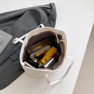 Interior view showing the large capacity of the white tote bag with M-pattern texture