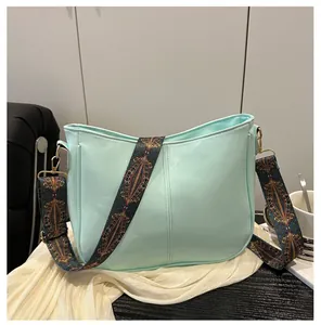 Detail of mint green PU leather tote bag with ethnic style wide printed shoulder strap