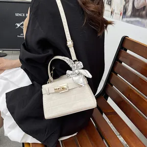 Elegant off-white crocodile embossed crossbody bag with silk scarf detail and gold lock