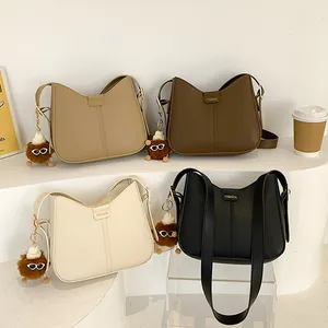 Minimalist women's shoulder bags in four colors with cute monster charms and fashion detail